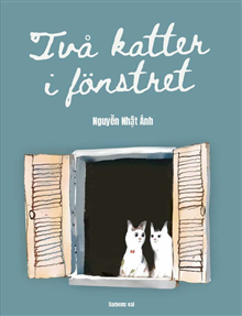 Två katter i fönstret